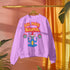 A Christmas sweatshirt featuring a playful design with a cartoon Baphomet goat character wearing a Santa hat. The design includes the text "All Hail Santa" above the goat, with pentagrams in flames on either side. The goat is depicted in a meditative pose, adding a humorous and irreverent twist to holiday attire.